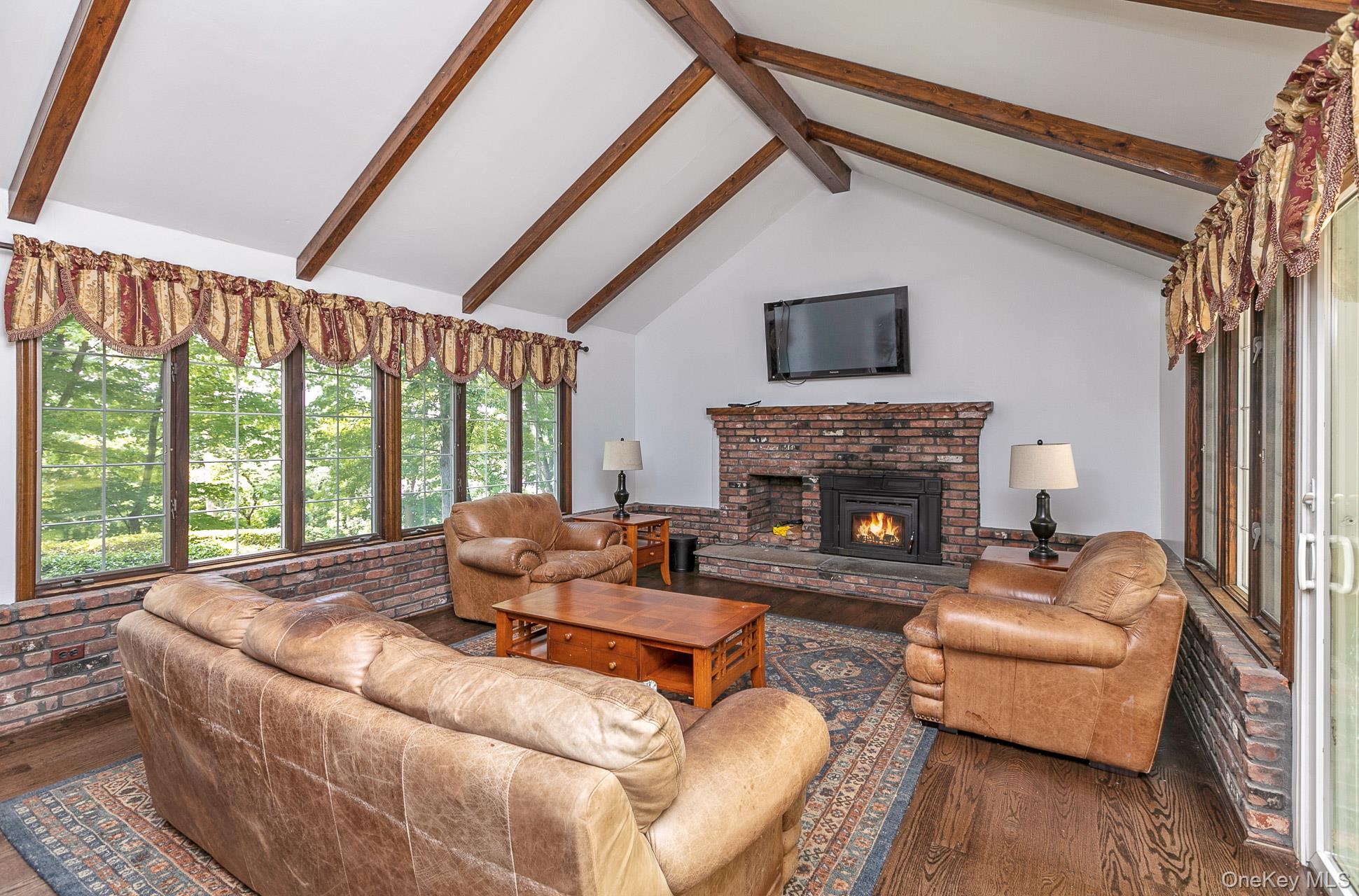 451 River Road St. James, NY 11780 - Photo 11 of 26 a living room with furniture and a fireplace