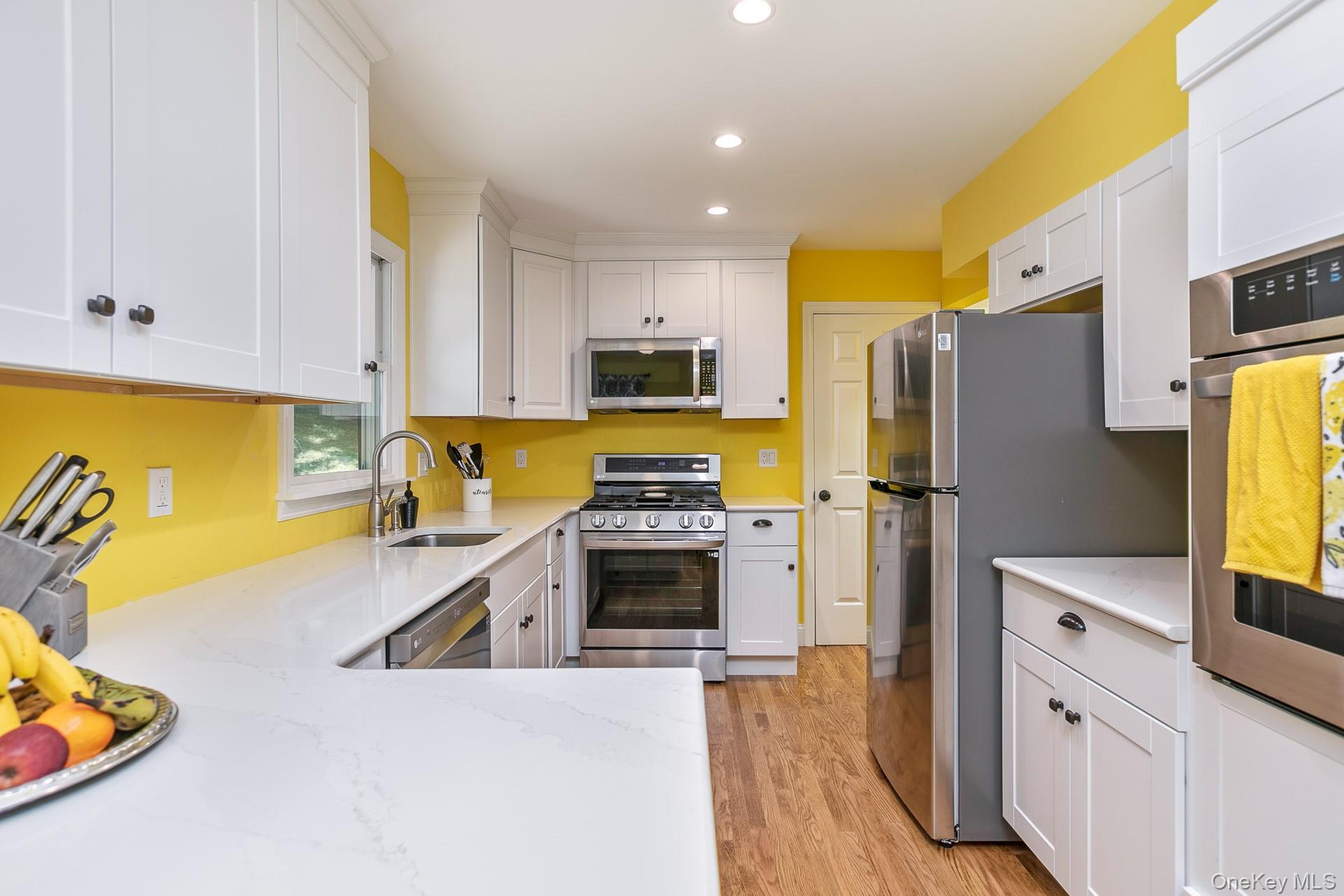 451 River Road St. James, NY 11780 - Photo 13 of 26 a kitchen with stainless steel appliances a stove refrigerator sink and a stove