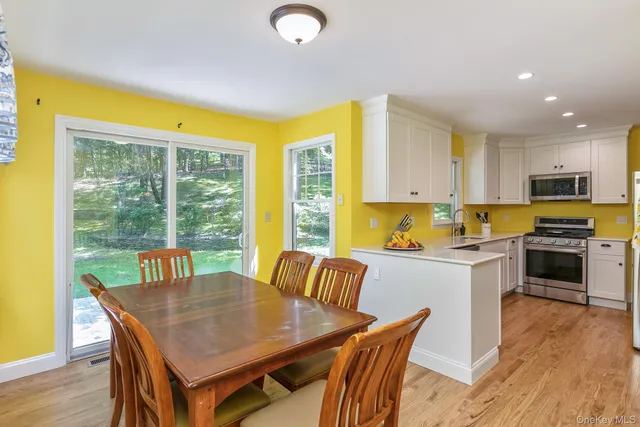 a kitchen with a table chairs sink and cabinets