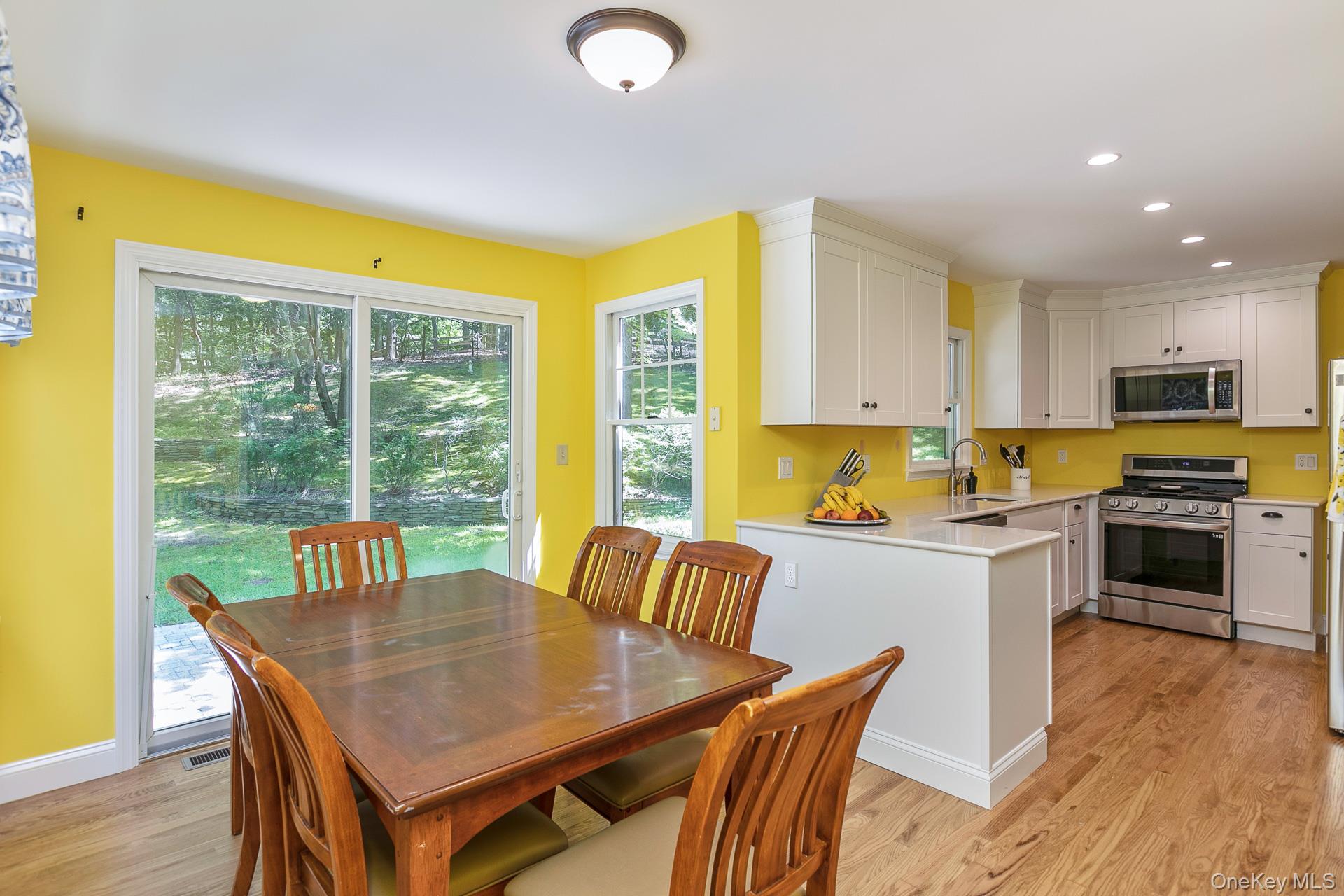 451 River Road St. James, NY 11780 - Photo 14 of 26 a kitchen with a table chairs sink and cabinets