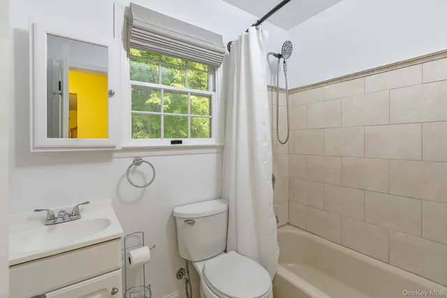 a bathroom with a sink vanity mirror and toilet