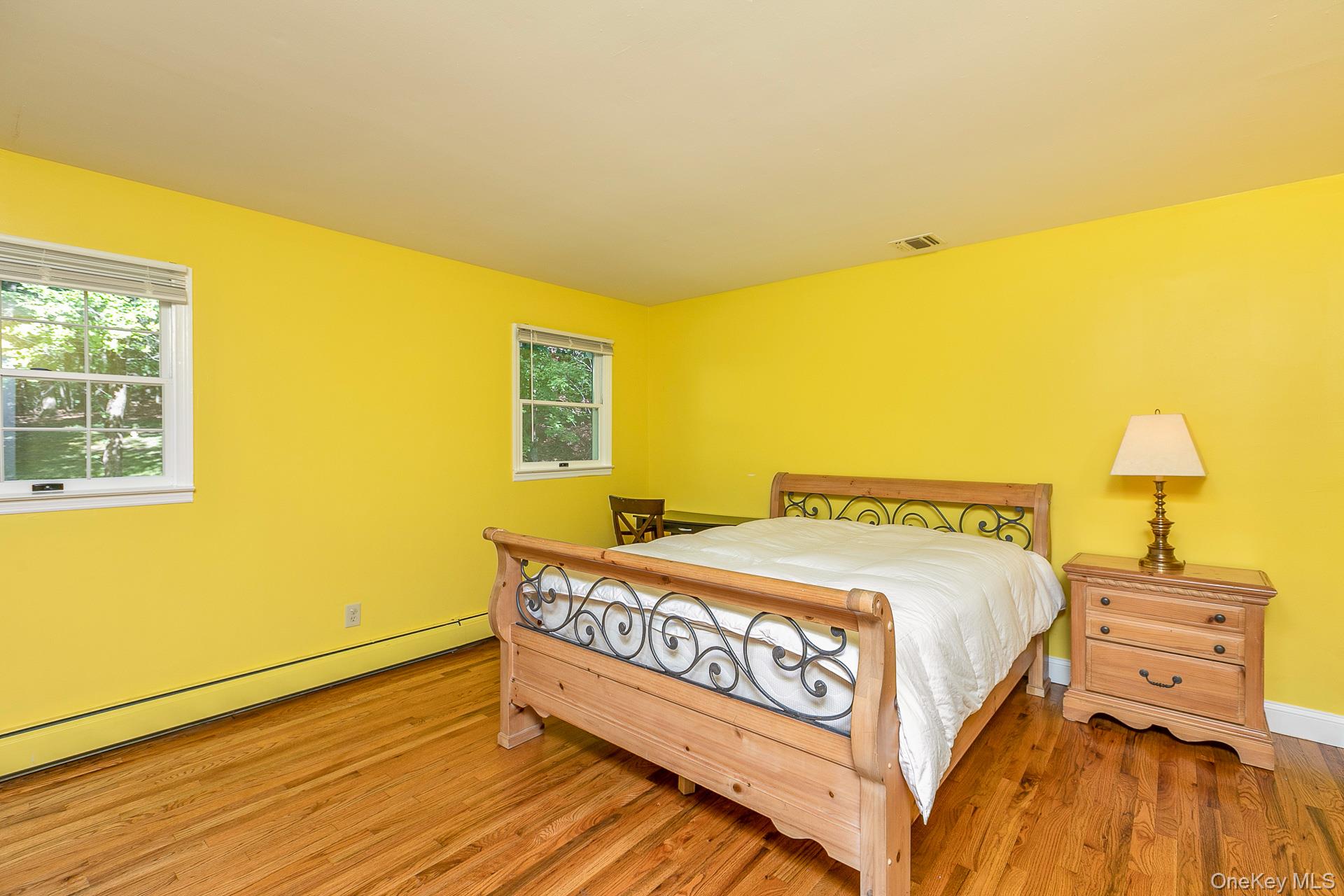 451 River Road St. James, NY 11780 - Photo 18 of 26 a bedroom with a bed and wooden floor