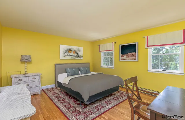 a living room with a bed furniture and a window