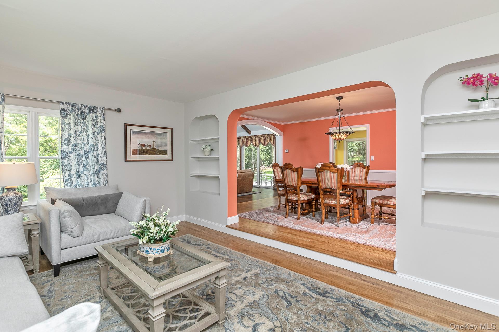 451 River Road St. James, NY 11780 - Photo 7 of 26 a living room with furniture and a dining table with wooden floor