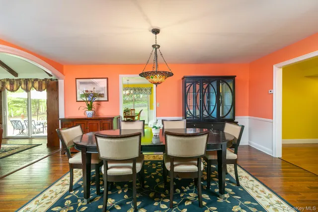 a dining room with furniture window and wooden floor