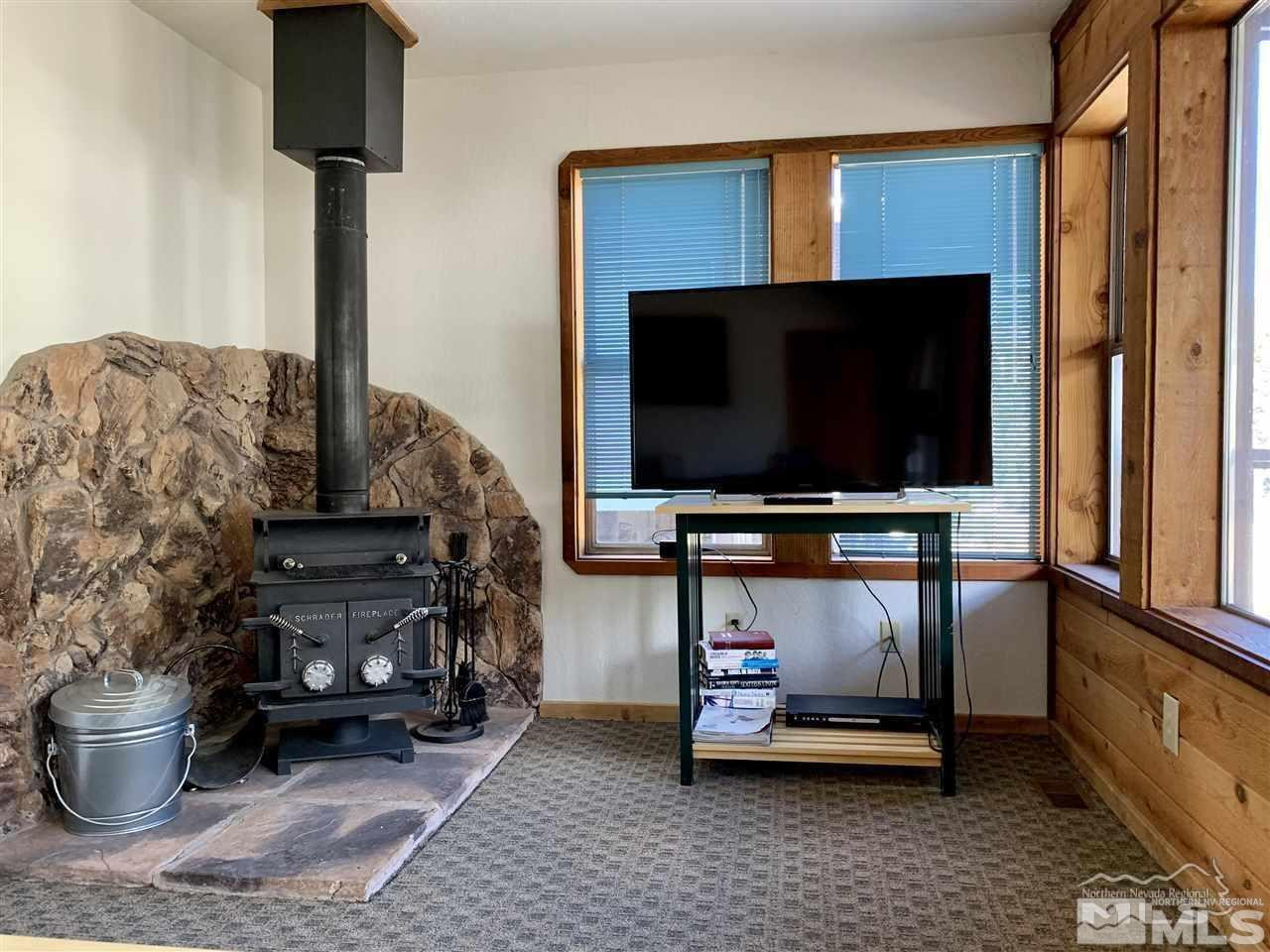 424 Quaking Aspen Lane, Unit B Stateline, NV 89449 - Photo 15 of 30 a living room with furniture and a flat screen tv