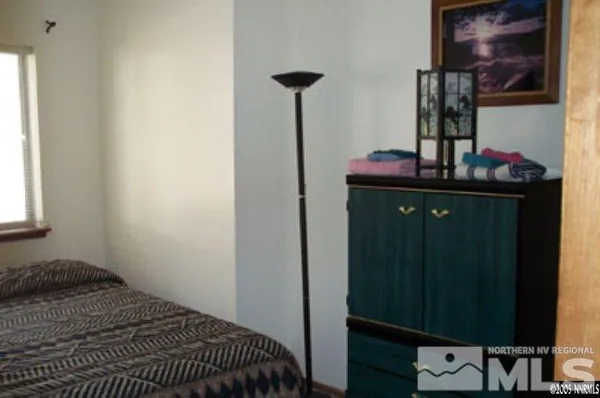 a bedroom with a bed and cabinets