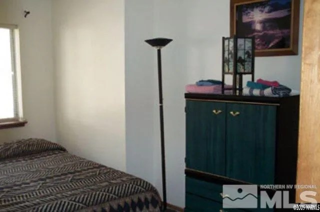 a bedroom with a bed and cabinets