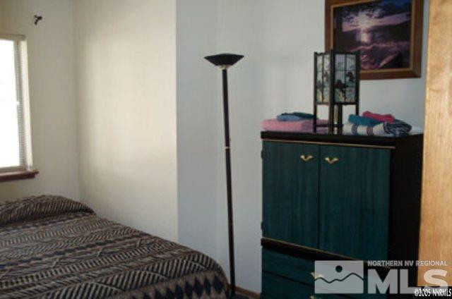 424 Quaking Aspen Lane, Unit B Stateline, NV 89449 - Photo 21 of 30 a bedroom with a bed and cabinets