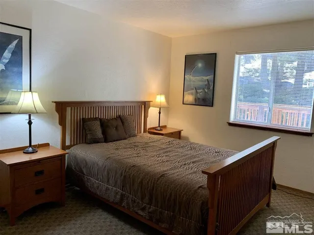 a bedroom with a bed and a night stand