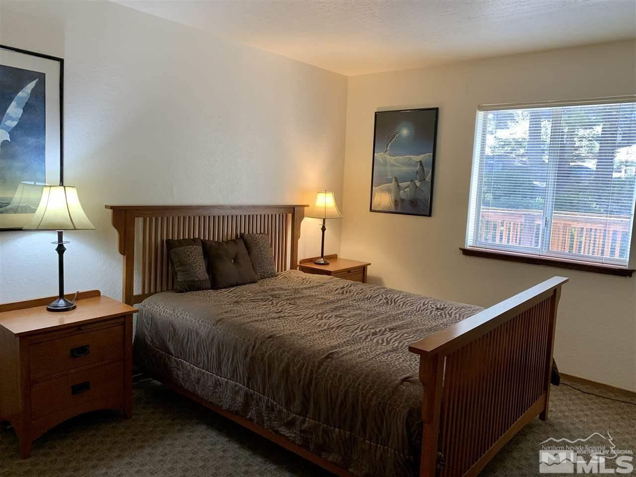 424 Quaking Aspen Lane, Unit B Stateline, NV 89449 - Photo 22 of 30 a bedroom with a bed and a night stand