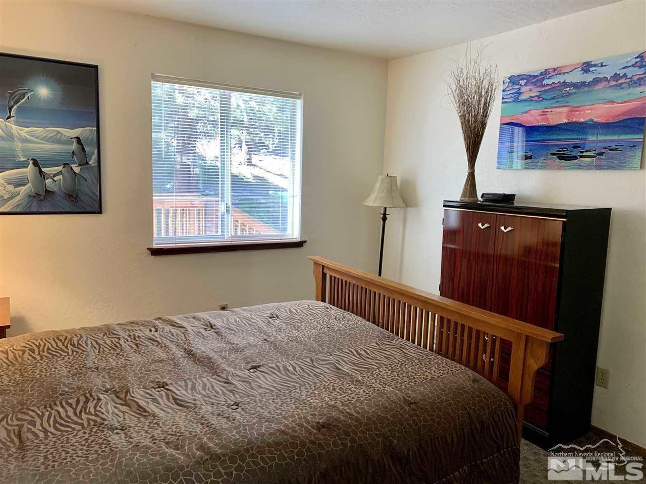 424 Quaking Aspen Lane, Unit B Stateline, NV 89449 - Photo 25 of 30 a bedroom with a bed and a window