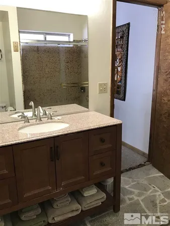 a bathroom with a sink vanity and a mirror