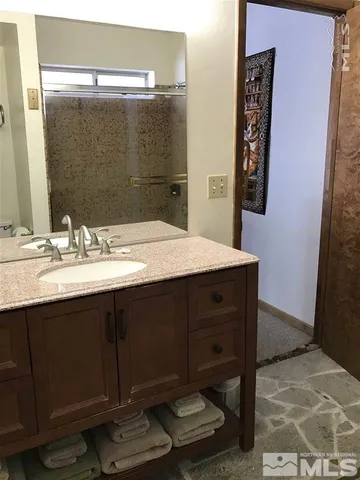 a bathroom with a sink vanity and a mirror