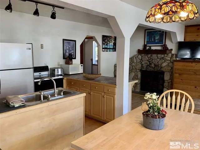 a kitchen with a refrigerator and a sink