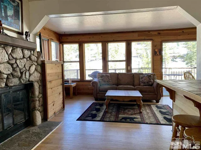 a living room with furniture and a floor to ceiling window