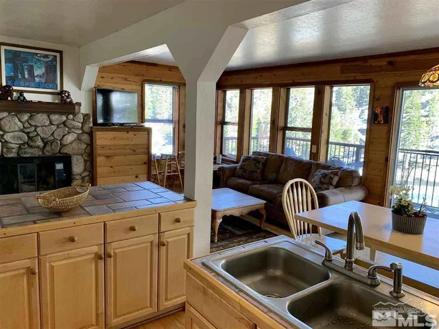 a kitchen with a sink and a stove next to a window