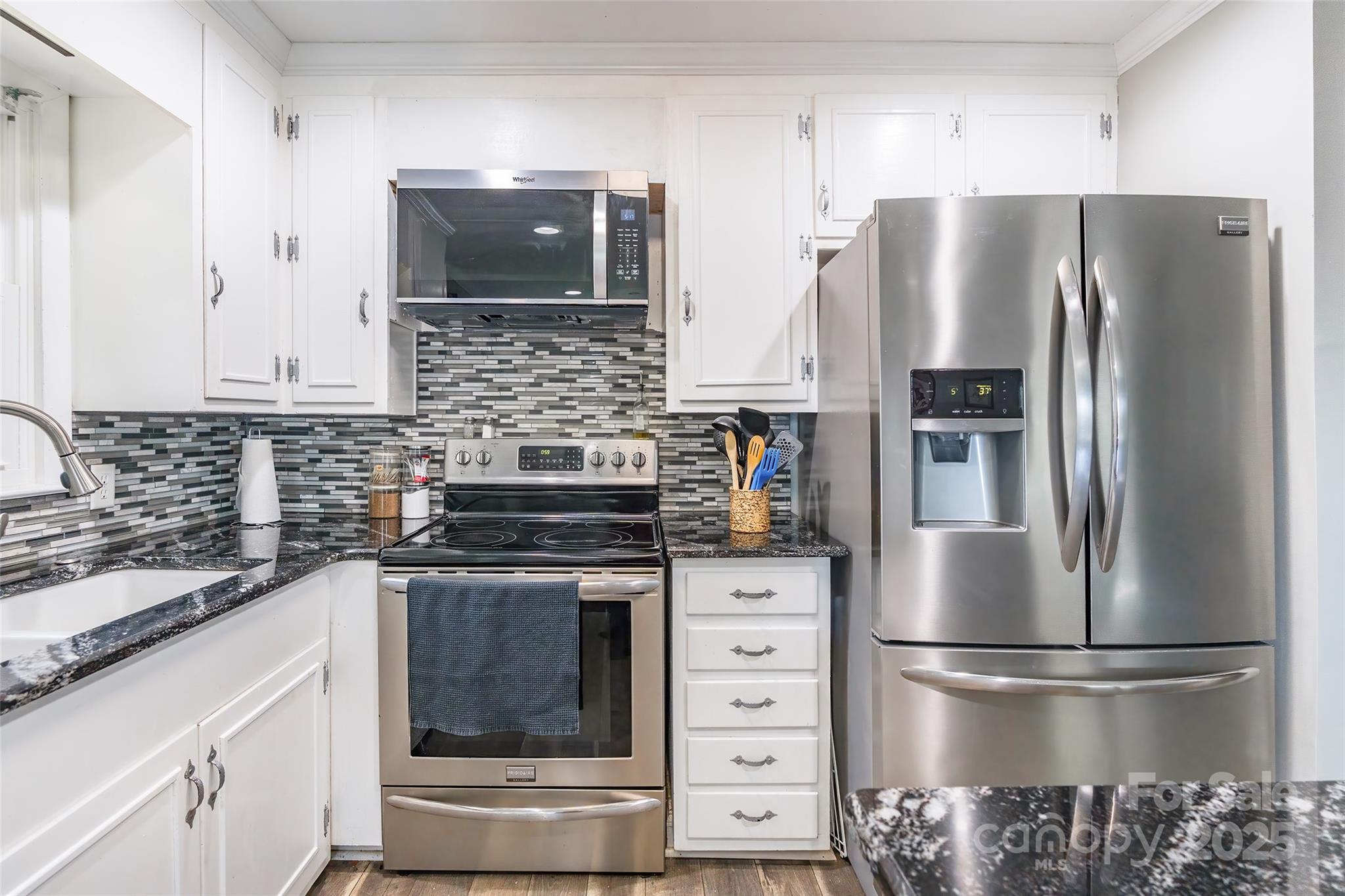 111 Berry Street Chester, SC 29706 - Photo 7 of 23 a kitchen with stainless steel appliances a refrigerator stove and sink