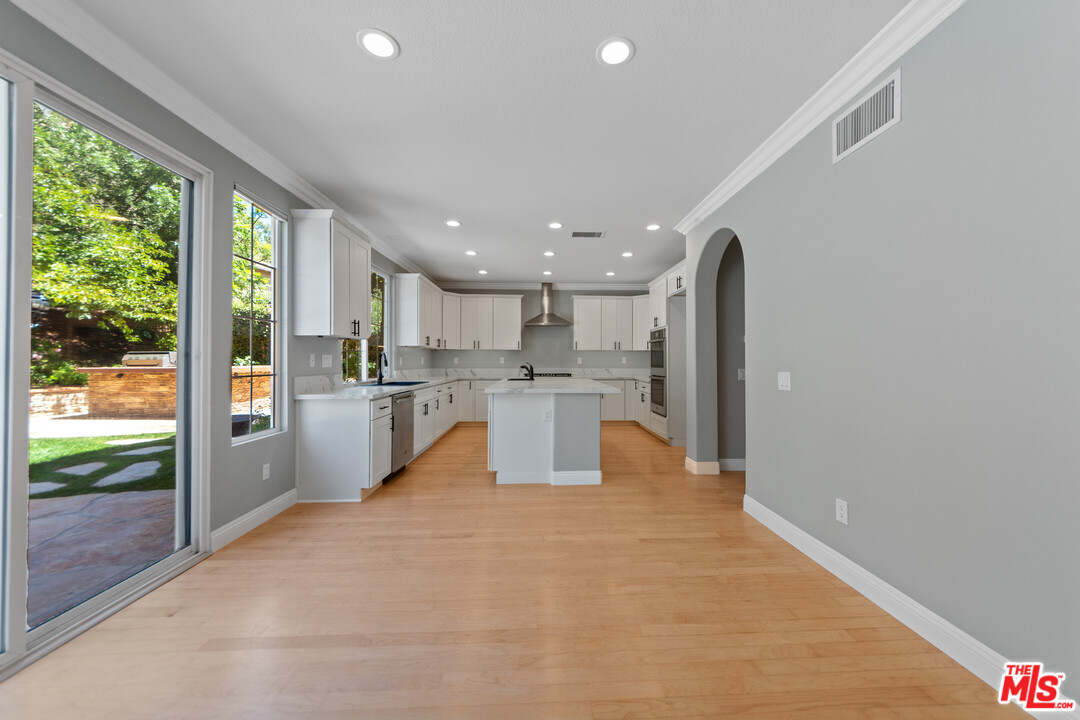 149 Laurel Ridge Drive Simi Valley, CA 93065 - Photo 16 of 53 a large white kitchen with large windows and a refrigerator