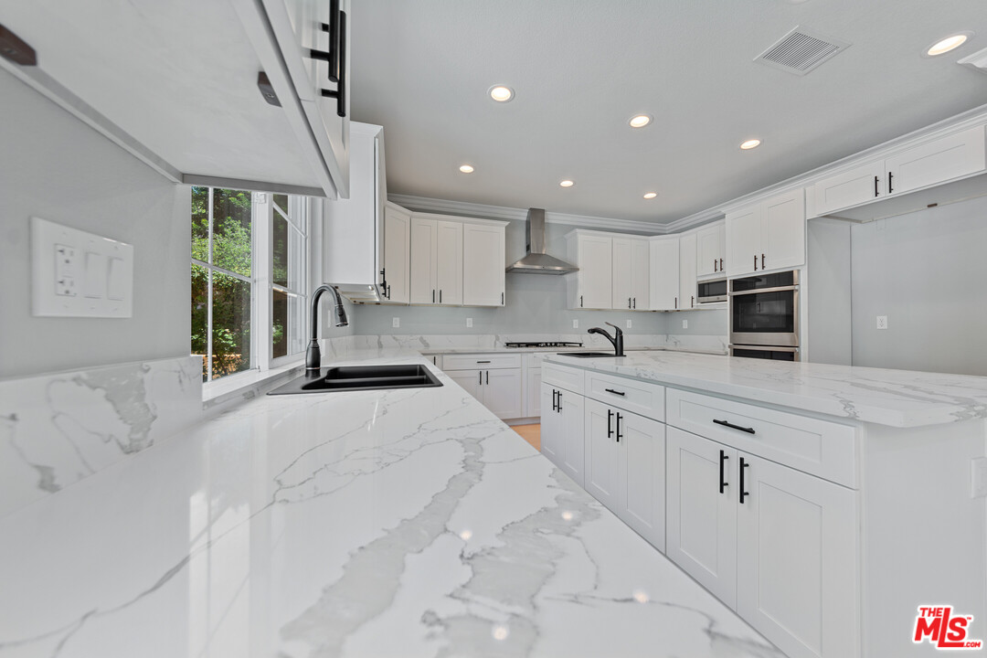 149 Laurel Ridge Drive Simi Valley, CA 93065 - Photo 21 of 53 a large kitchen with stainless steel appliances kitchen island granite countertop a sink and cabinets