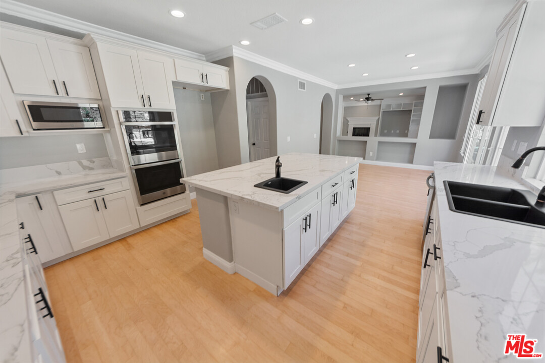 149 Laurel Ridge Drive Simi Valley, CA 93065 - Photo 22 of 53 a kitchen with stainless steel appliances kitchen island granite countertop a refrigerator and a stove top oven