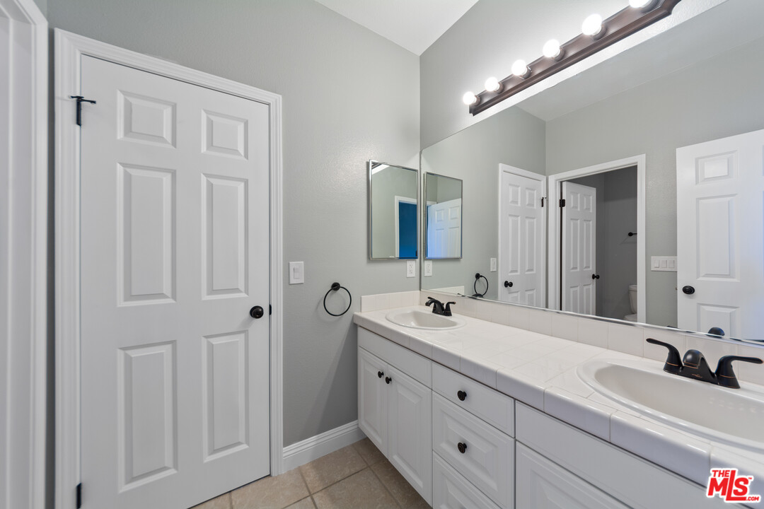 149 Laurel Ridge Drive Simi Valley, CA 93065 - Photo 44 of 53 a bathroom with a double vanity sink and a mirror