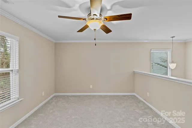 a view of room with window and ceiling fan