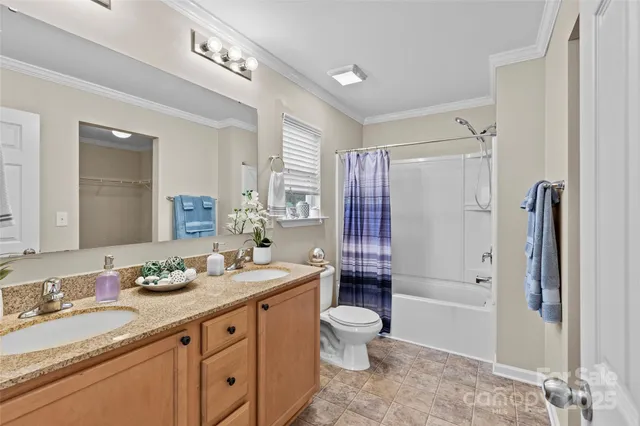 a spacious bathroom with a granite countertop sink toilet and shower