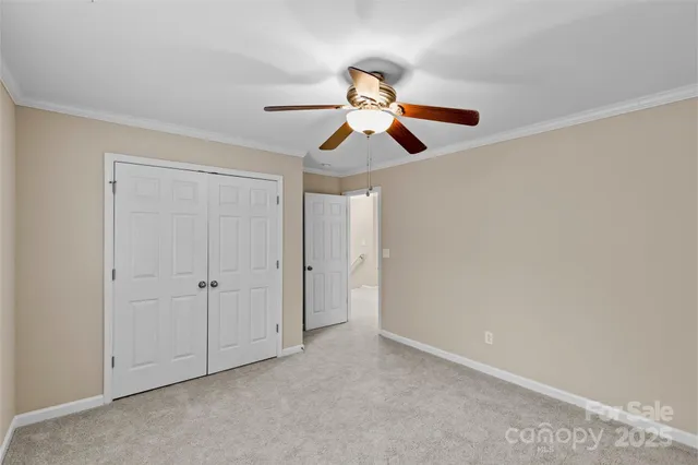 a view of a room with a ceiling fan