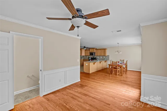 a view of dining room and livingroom with furniture wooden floor and a ceiling fan