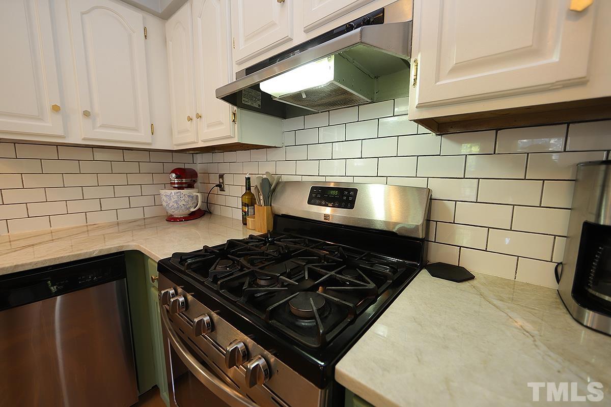 3301 East Jameson Road Raleigh, NC 27604 - Photo 11 of 29 a stove top oven sitting inside of a kitchen