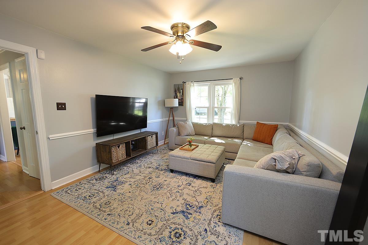 3301 East Jameson Road Raleigh, NC 27604 - Photo 14 of 29 a living room with furniture and a flat screen tv