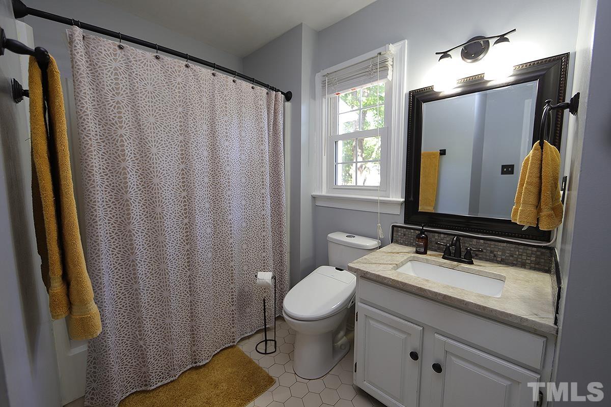 3301 East Jameson Road Raleigh, NC 27604 - Photo 15 of 29 a bathroom with a granite countertop sink toilet and mirror