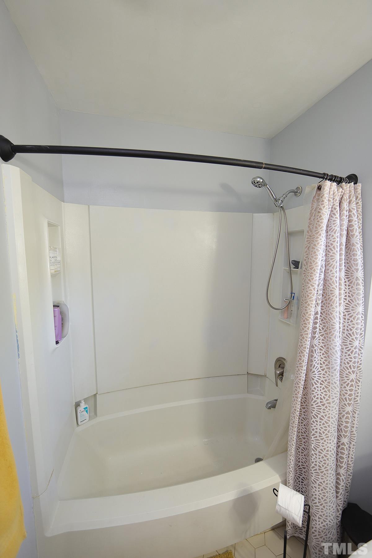 3301 East Jameson Road Raleigh, NC 27604 - Photo 16 of 29 a bathroom with a shower and a bath tub
