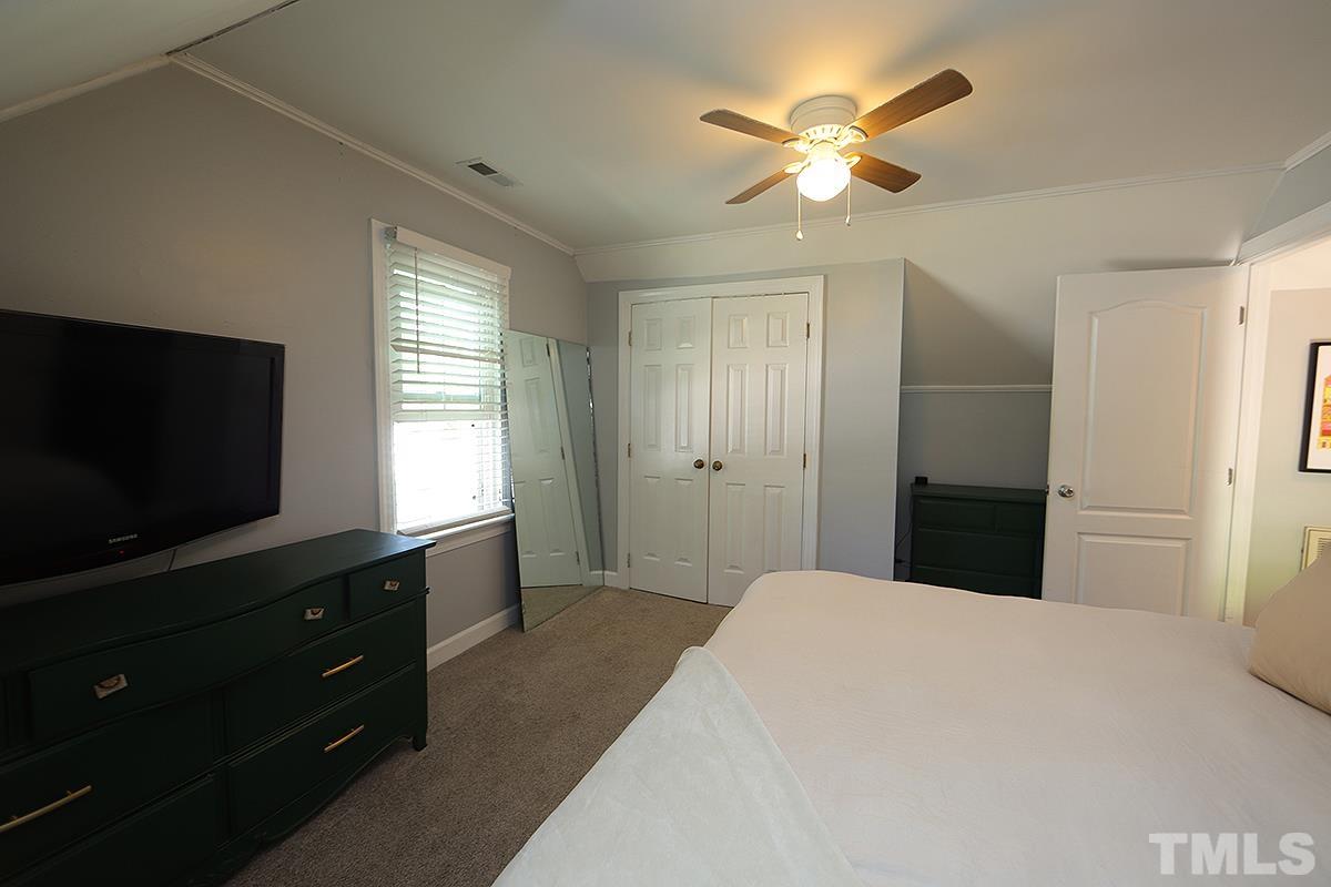 3301 East Jameson Road Raleigh, NC 27604 - Photo 17 of 29 a bedroom with a bed and a flat screen tv