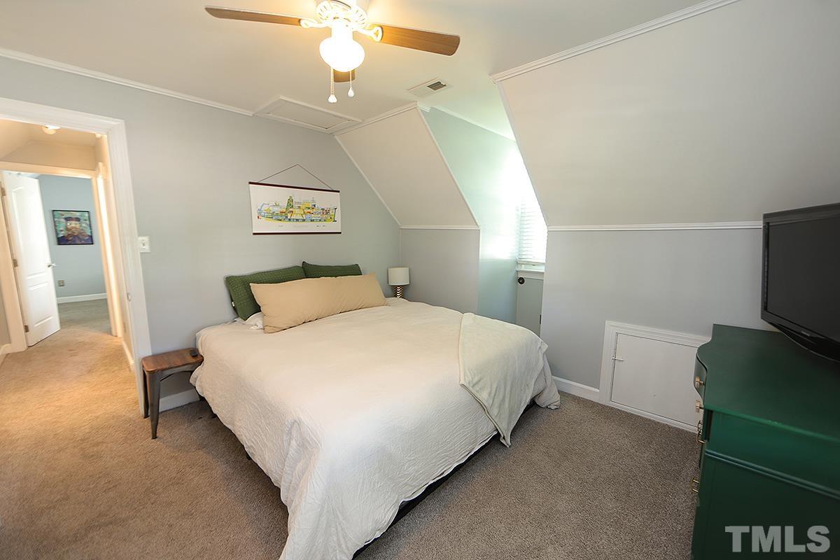 3301 East Jameson Road Raleigh, NC 27604 - Photo 18 of 29 a bedroom with a bed and a flat tv screen on dresser