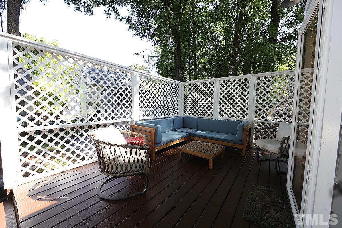 3301 East Jameson Road Raleigh, NC 27604 - Photo 21 of 29 a balcony with wooden floor table and chair