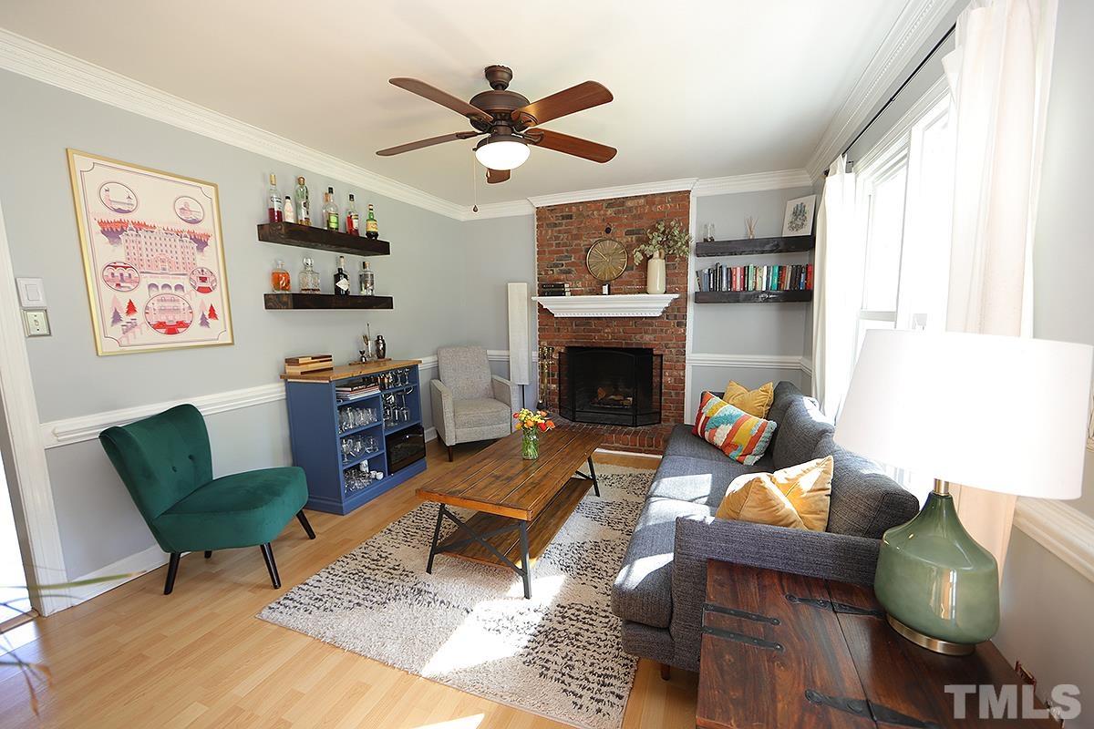 3301 East Jameson Road Raleigh, NC 27604 - Photo 5 of 29 a living room with furniture kitchen view and a fireplace