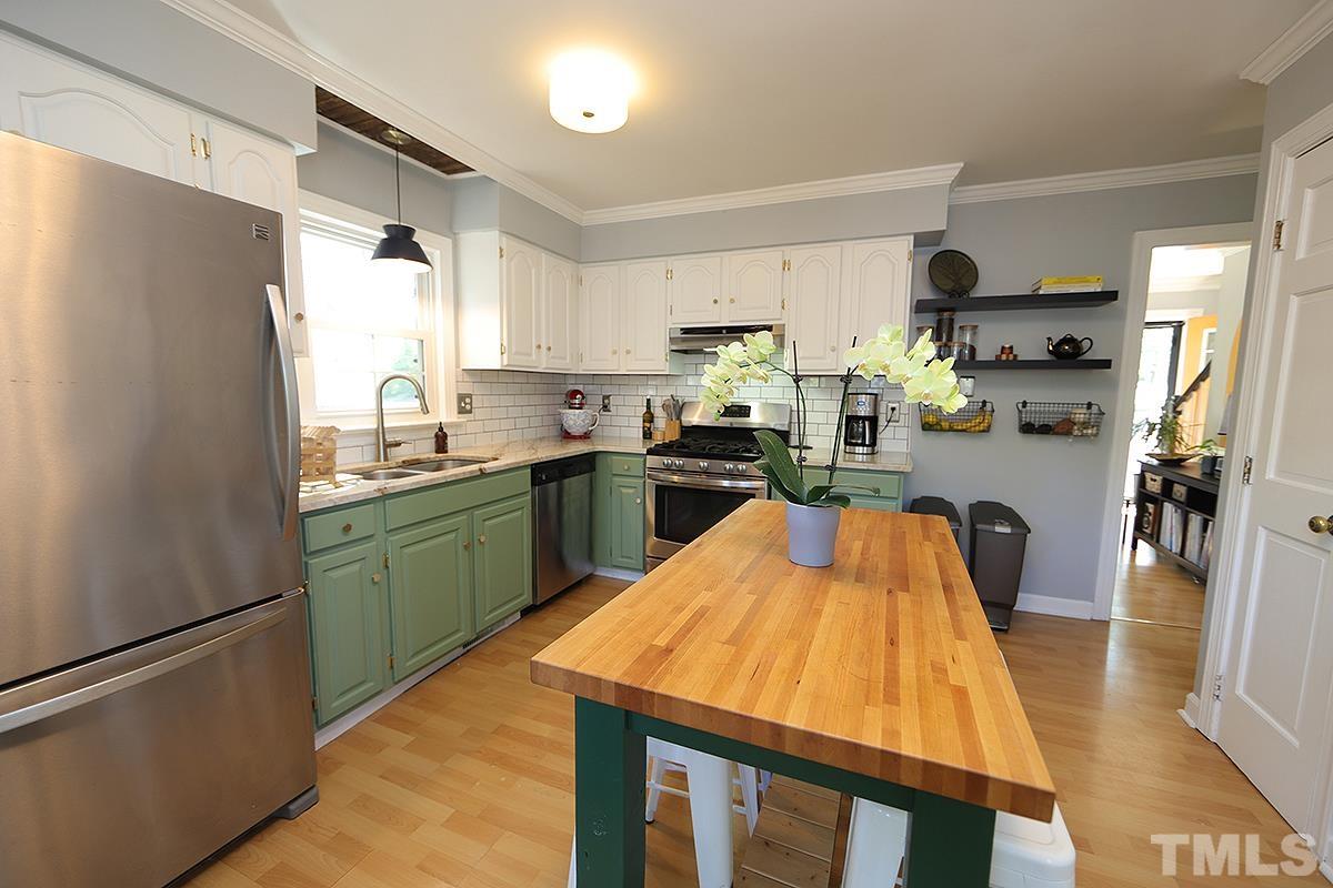 3301 East Jameson Road Raleigh, NC 27604 - Photo 9 of 29 a kitchen with a refrigerator a sink dishwasher and a stove