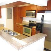 a kitchen with stainless steel appliances granite countertop a sink refrigerator and microwave