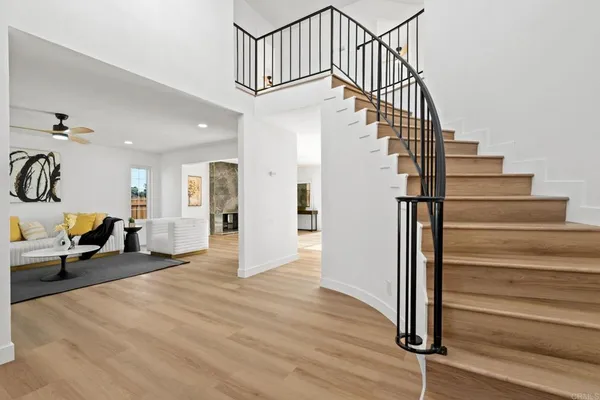a view of entryway and hall with wooden floor