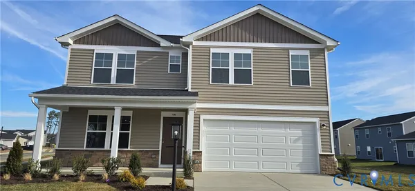 a front view of a house with garage