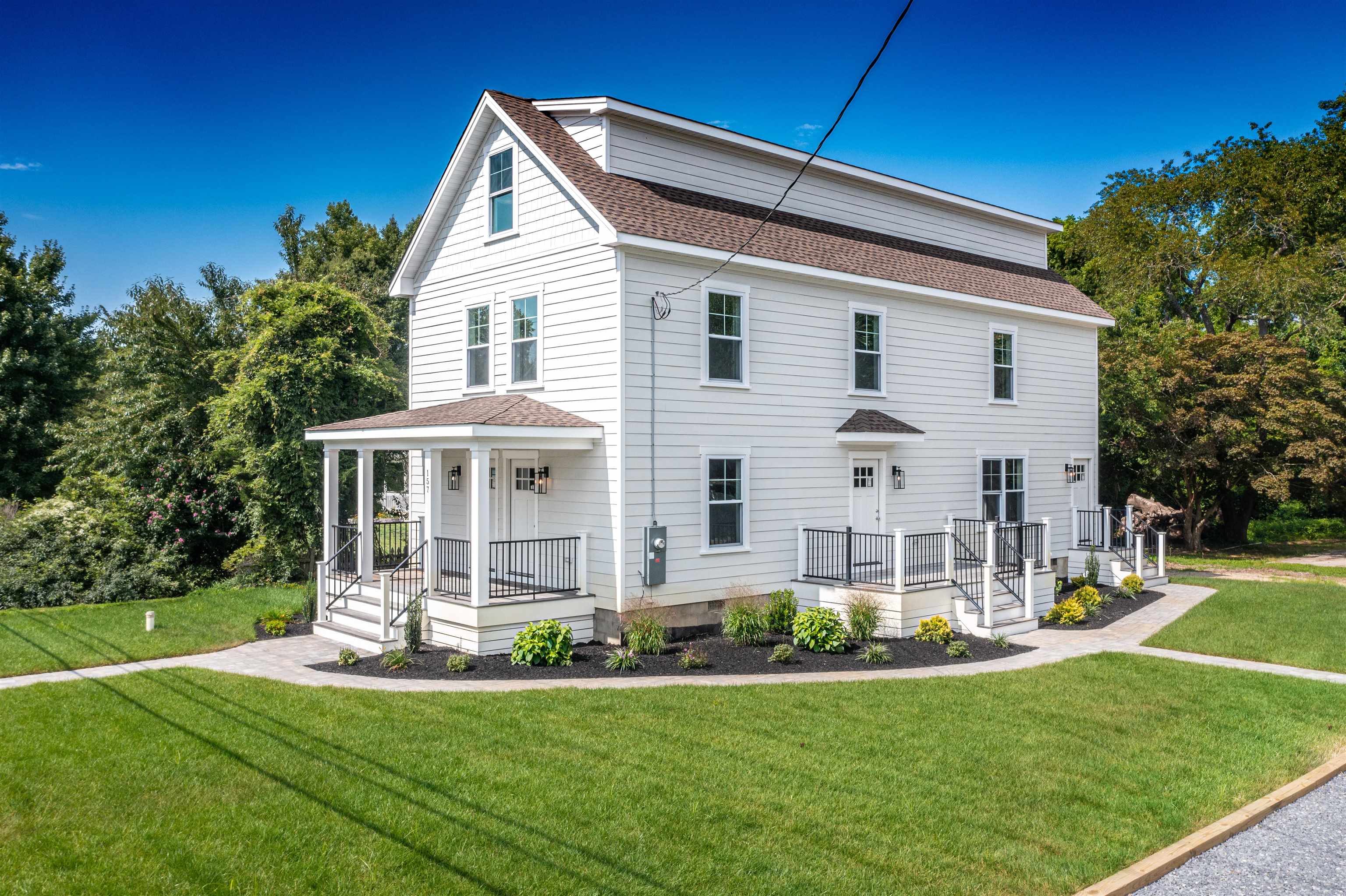 a front view of a house with a yard table and chairs