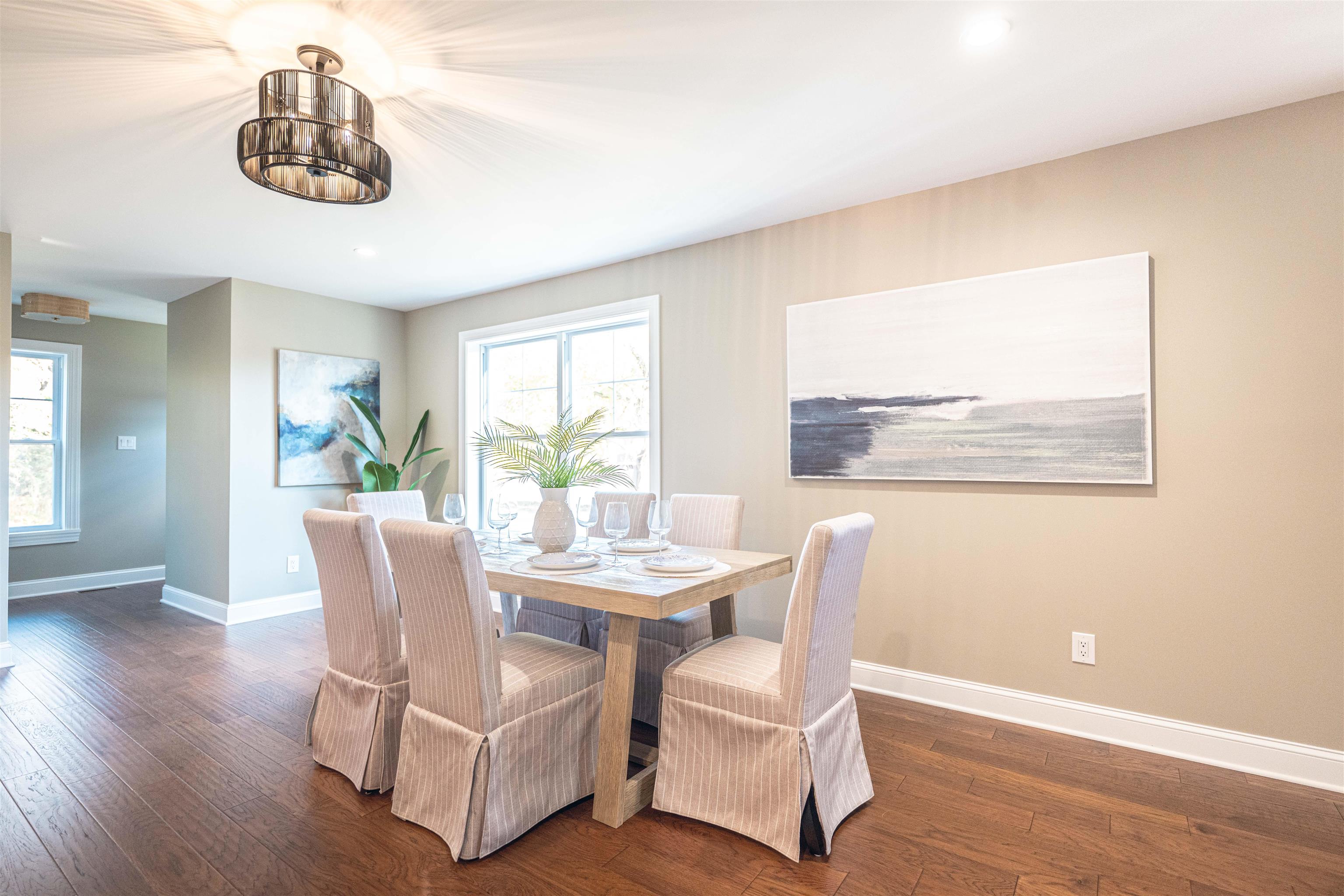 157 Fishing Creek Road North Cape May, NJ 08204 - Photo 17 of 50 a dining room with furniture a window and wooden floor