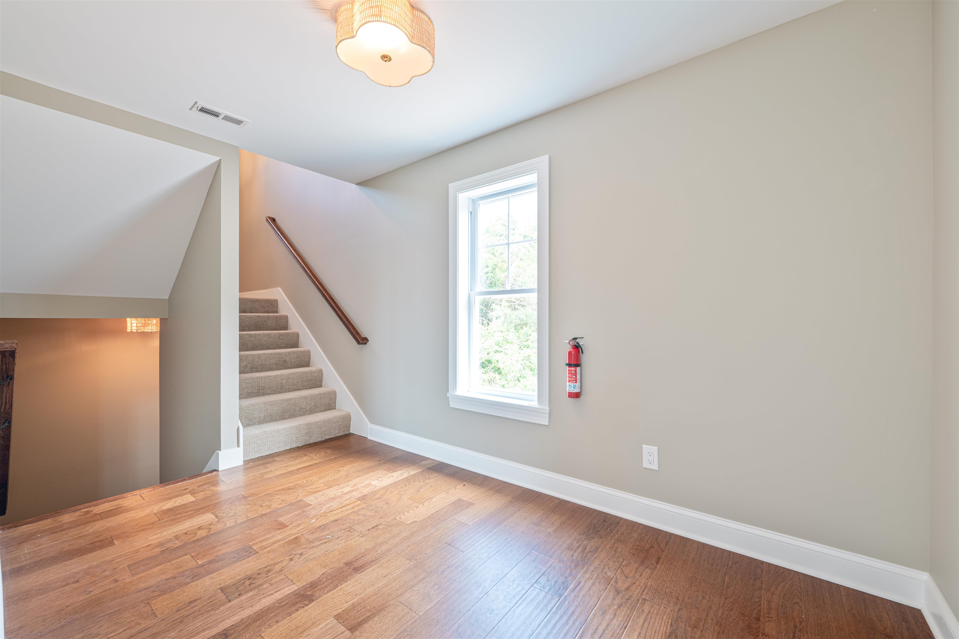 157 Fishing Creek Road North Cape May, NJ 08204 - Photo 19 of 50 a view of an empty room with wooden floor and stairs