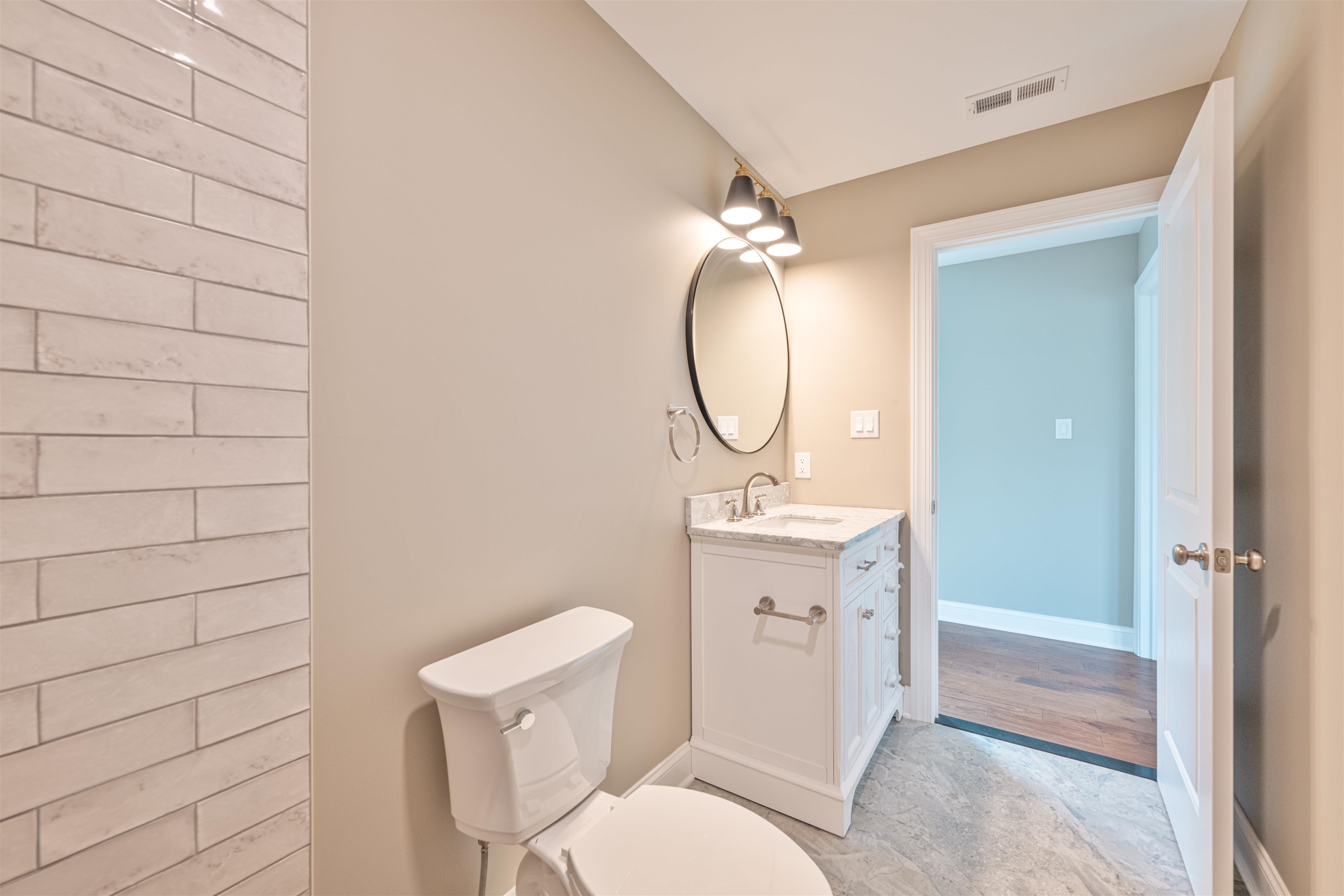 157 Fishing Creek Road North Cape May, NJ 08204 - Photo 32 of 50 a bathroom with a granite countertop toilet sink and a mirror