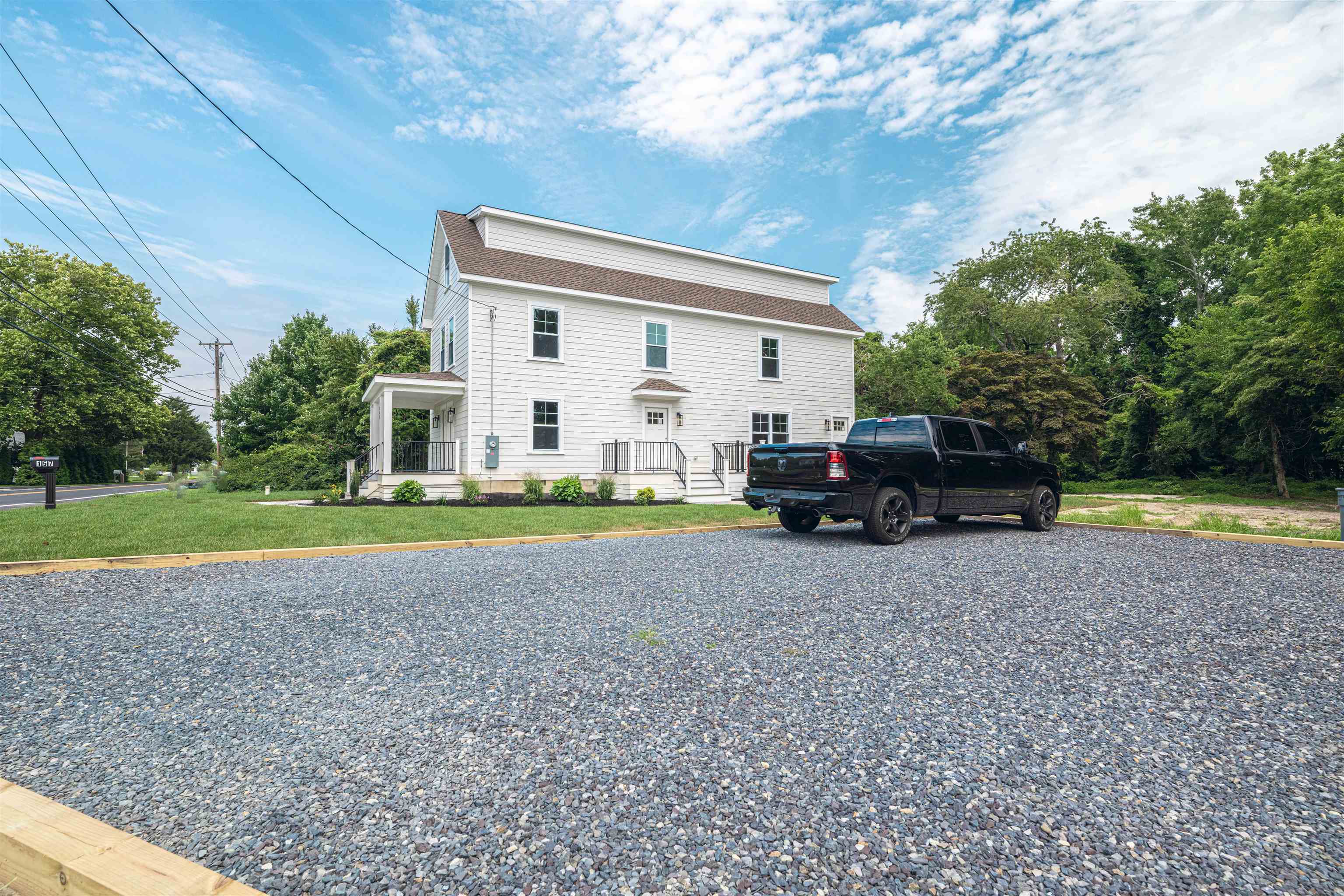 157 Fishing Creek Road North Cape May, NJ 08204 - Photo 49 of 50 a car parked in front of a house with large trees