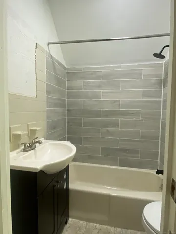a bathroom with a sink mirror toilet and bathtub