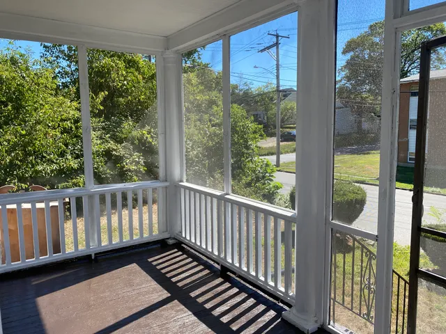 a view of a balcony with wooden floor