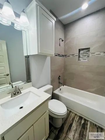 a bathroom with a sink a toilet and bathtub